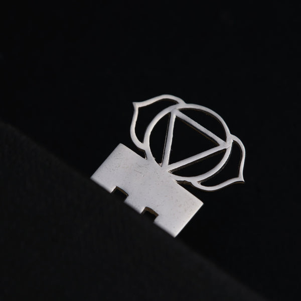 a close up of a metal object on a black surface