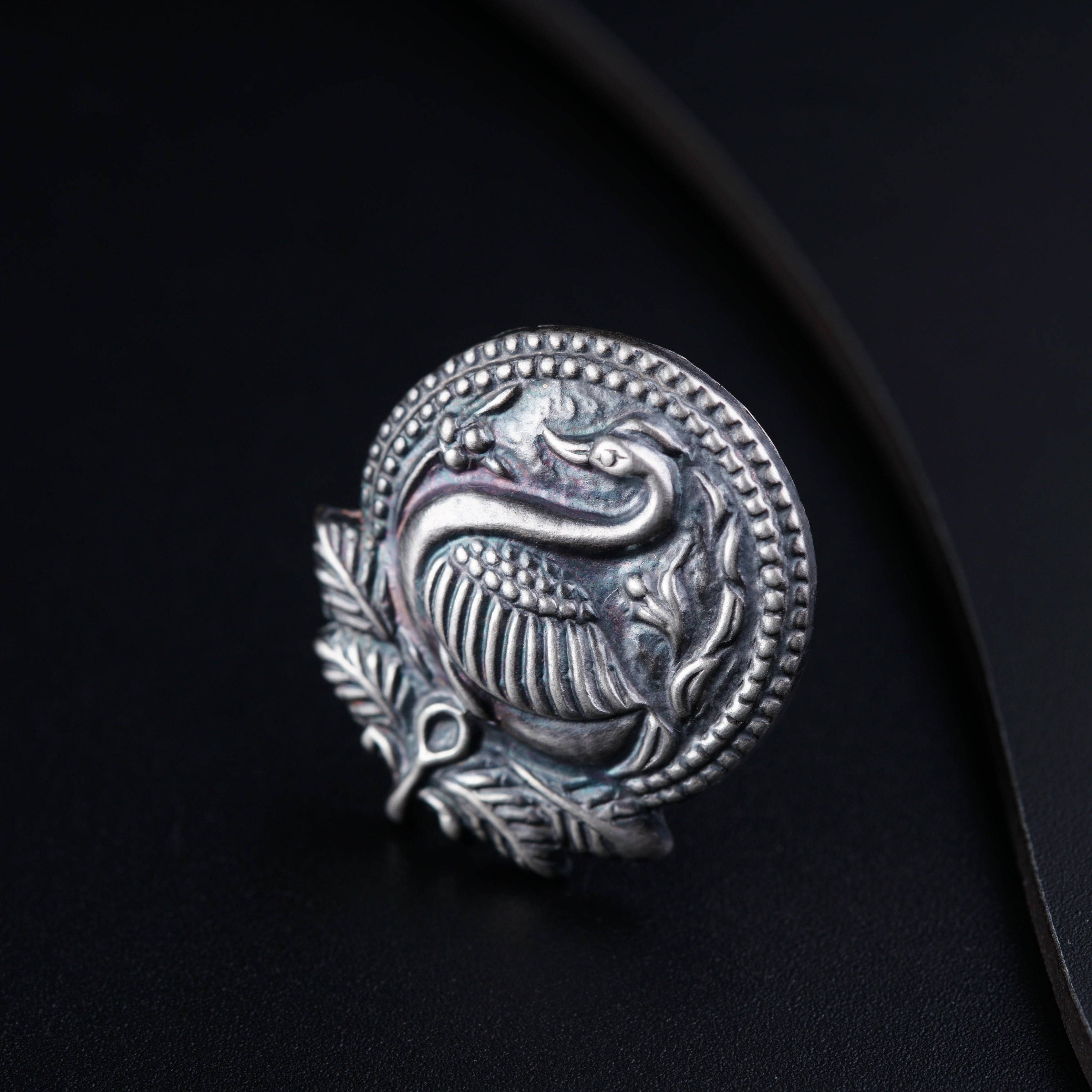 a silver ring with a snake on it