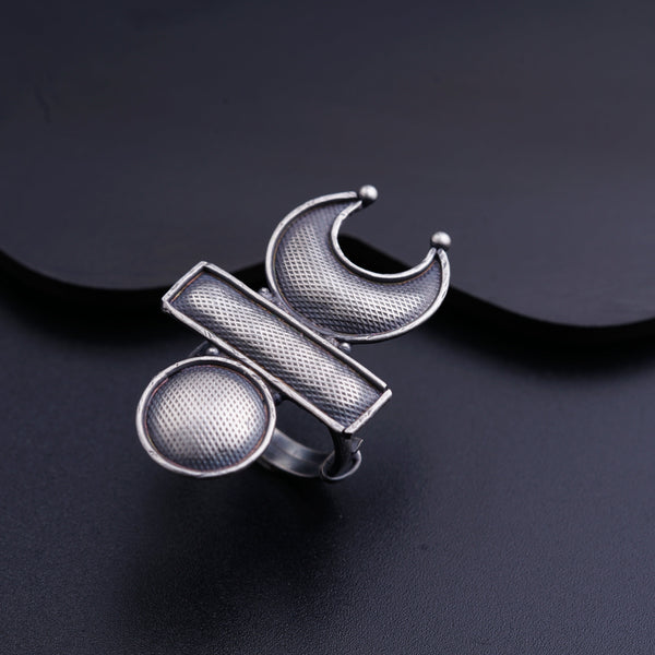 a silver ring sitting on top of a black surface