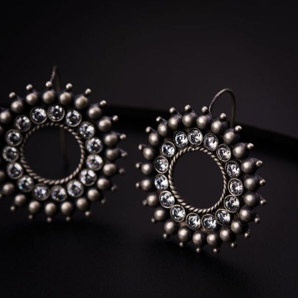 a pair of earrings sitting on top of a table