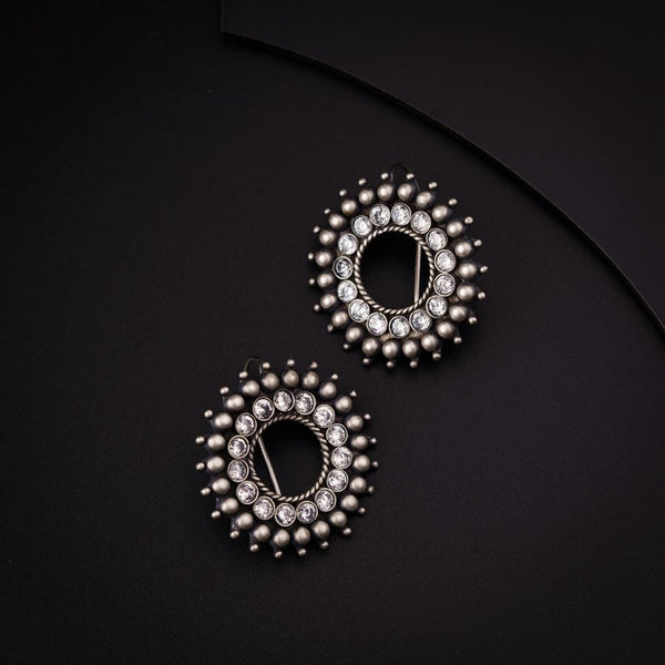 a pair of earrings on a black surface
