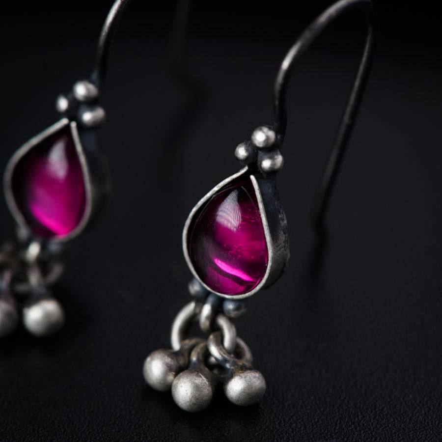 a pair of silver and pink glass earrings