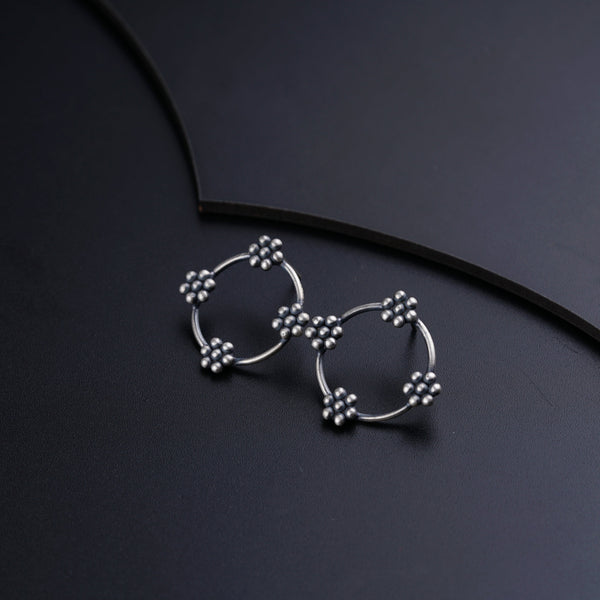 a pair of earrings sitting on top of a table