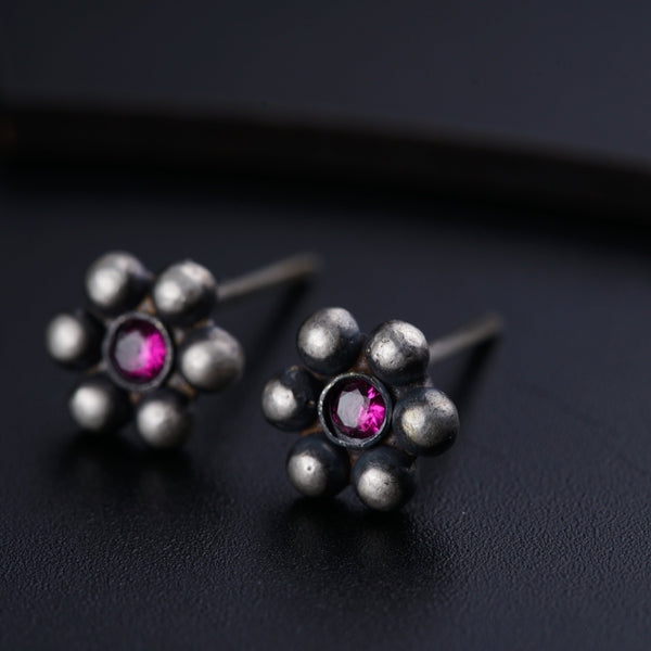 a pair of silver and pink stone earrings