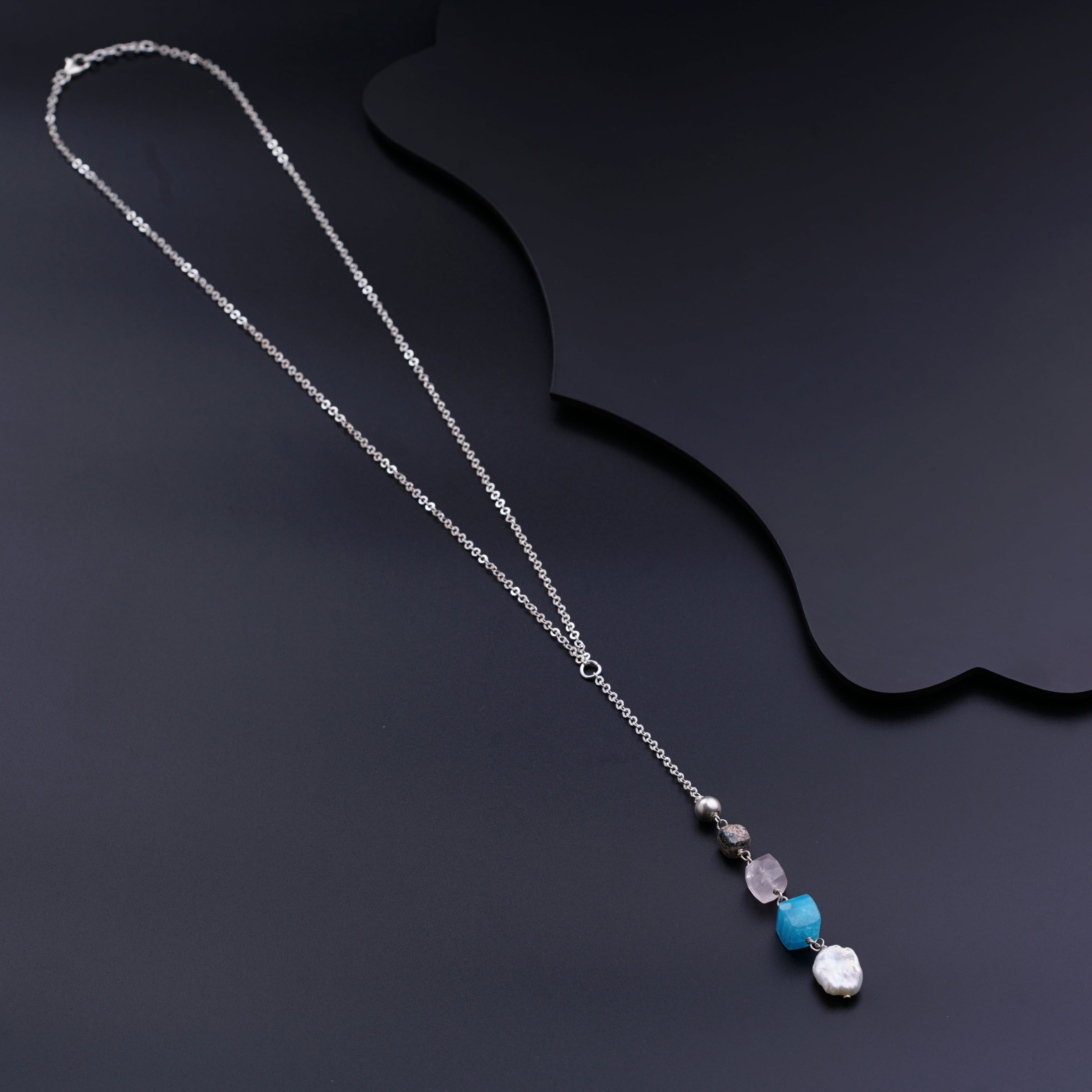 a silver chain with a blue and white bead hanging from it