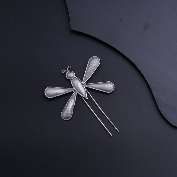 a dragonfly brooch with a pair of scissors