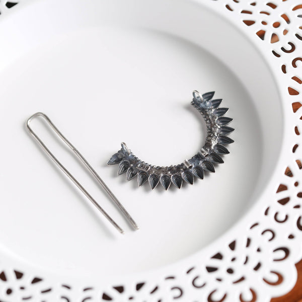 a white plate topped with a pair of pins