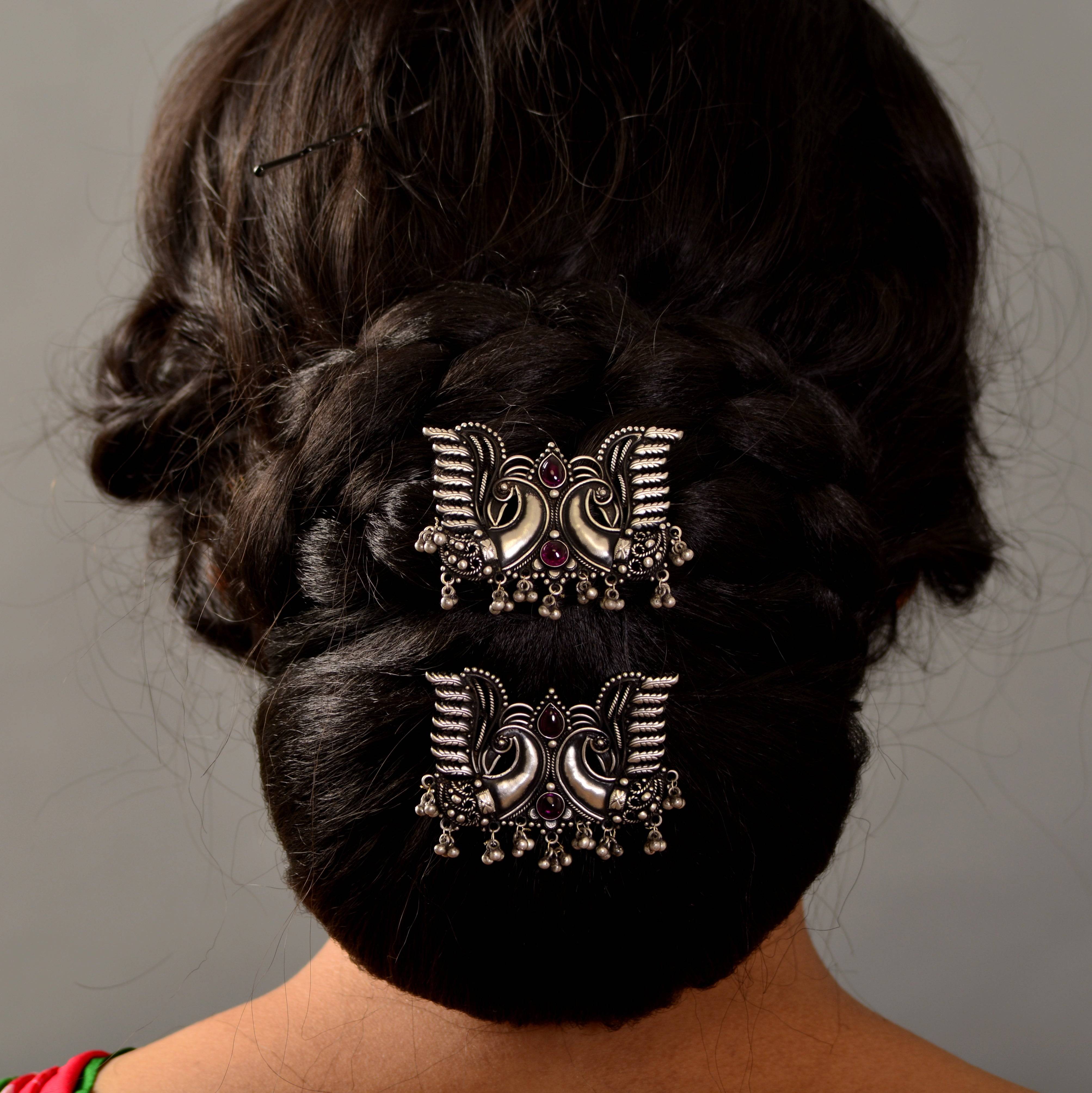 a close up of a woman's back with two hair clips in her hair