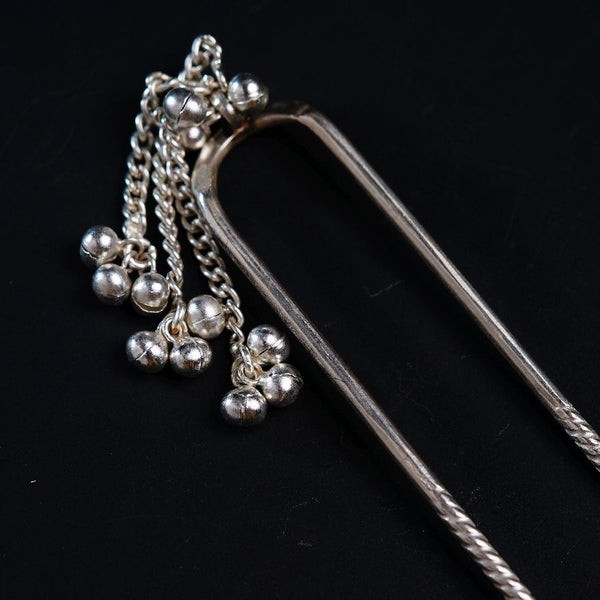 a close up of a metal object on a black surface