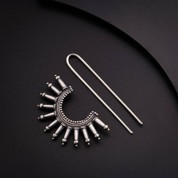 a pair of earrings and a pair of needles