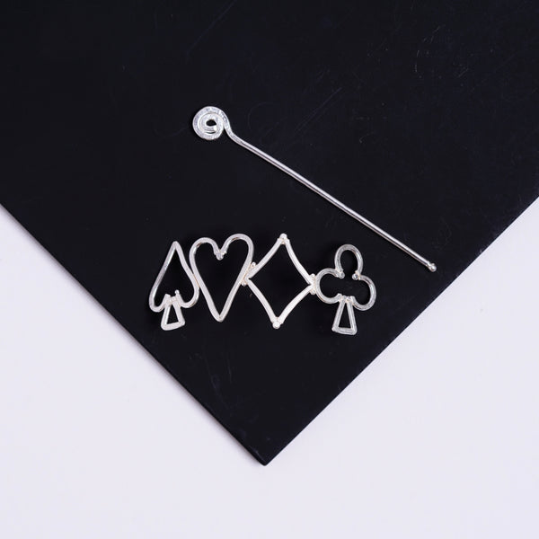 a pair of earrings sitting on top of a black piece of paper