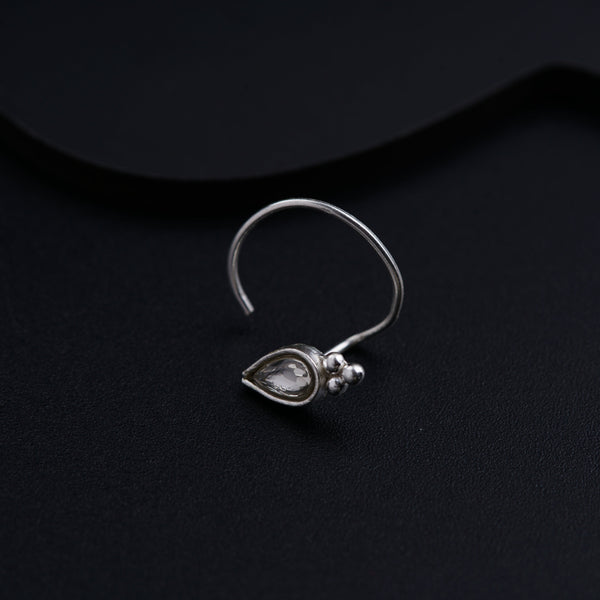 a close up of a pair of earrings on a black surface