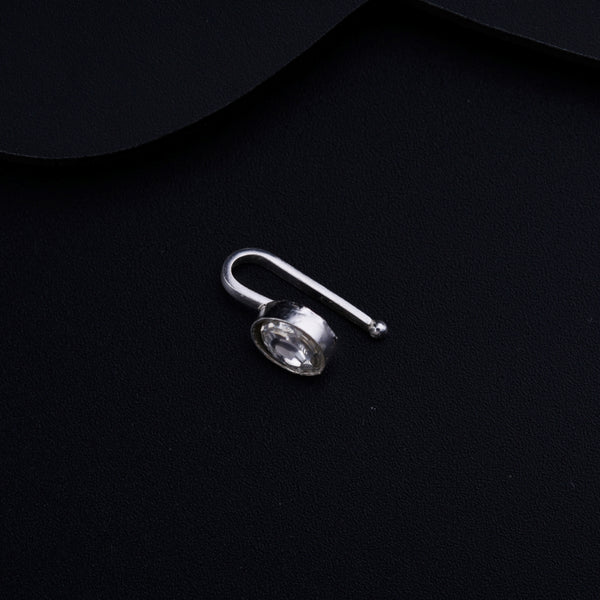 a pair of earrings sitting on top of a black surface