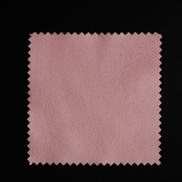 a piece of pink paper on a black background