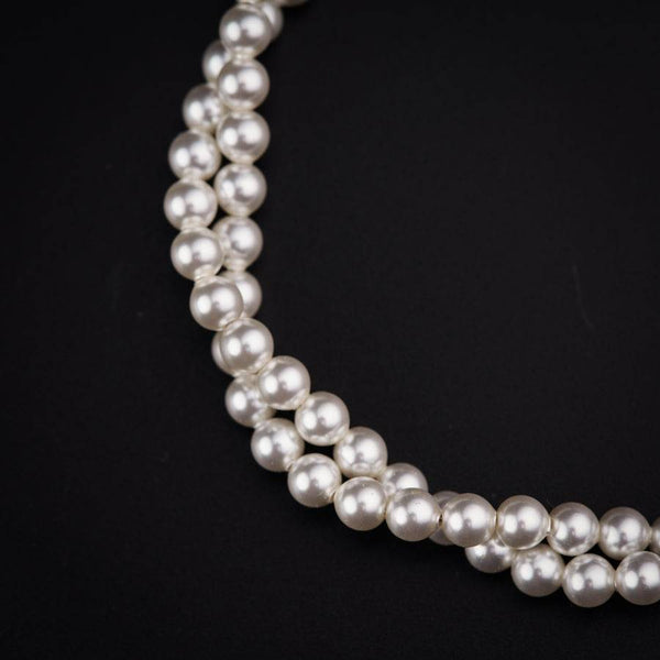 a close up of a necklace on a black background