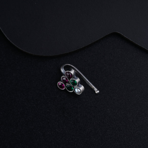 a pair of earrings sitting on top of a black surface