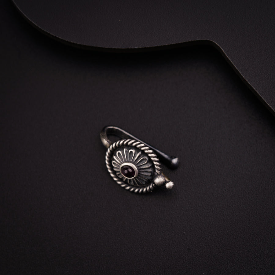 a close up of a metal object on a black surface