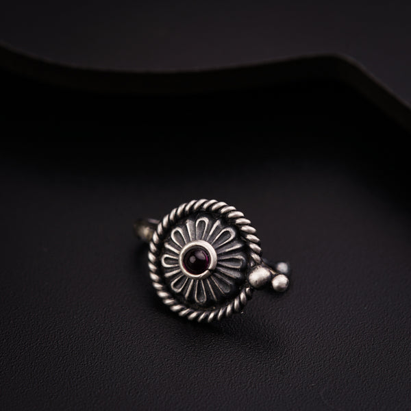 a close up of a ring on a black surface