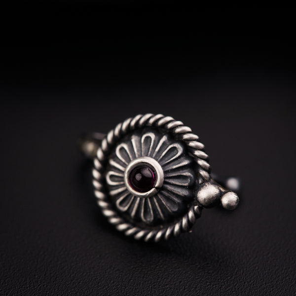 a close up of a ring on a black surface