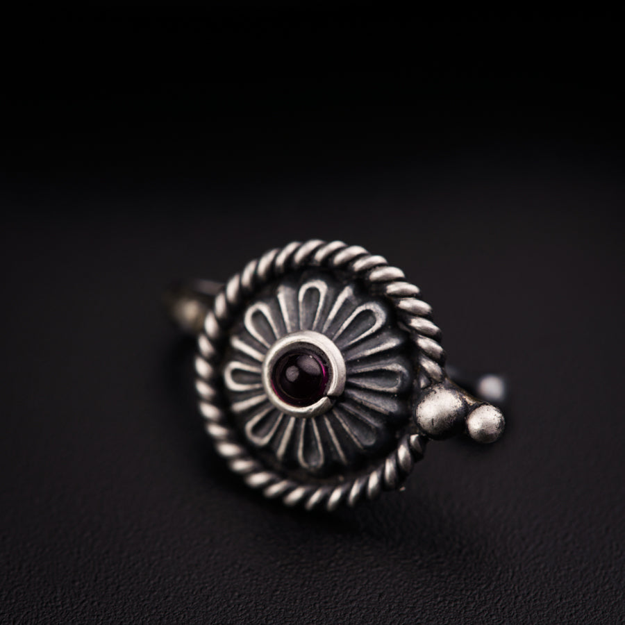a close up of a ring on a black surface