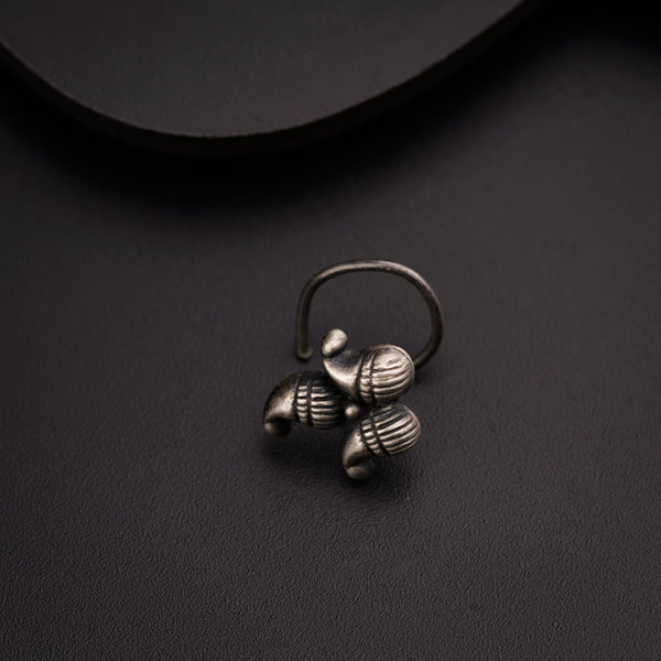 a small silver ring sitting on top of a table