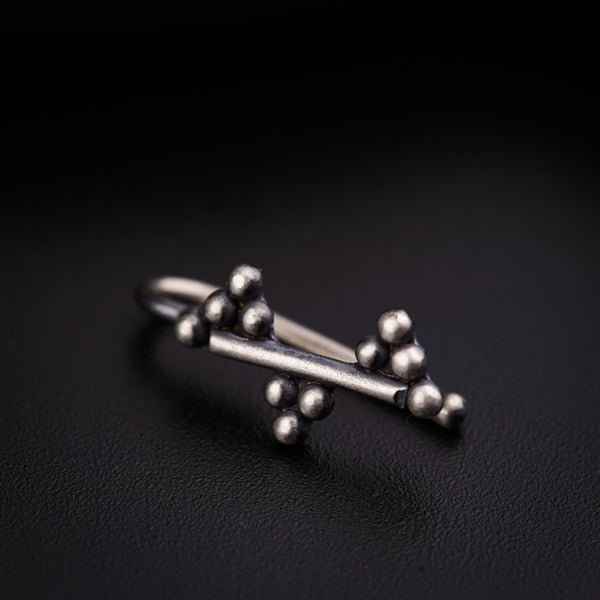 a close up of a metal object on a black surface