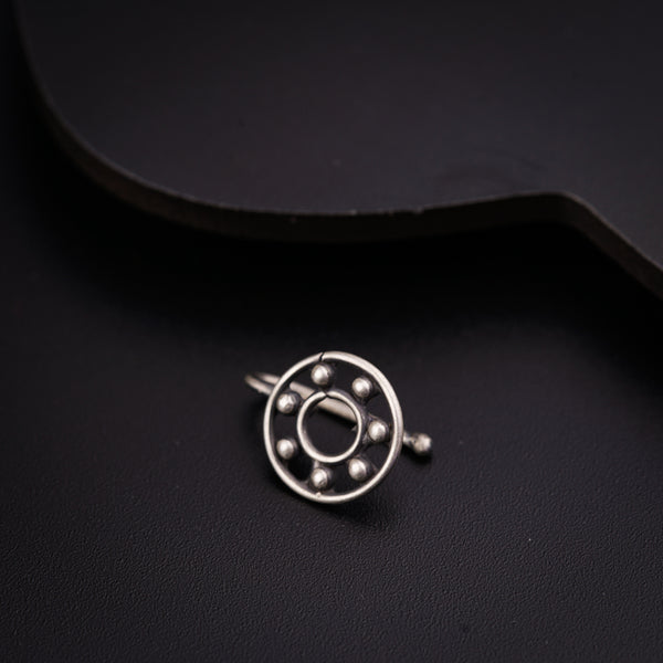 a close up of a metal object on a black surface