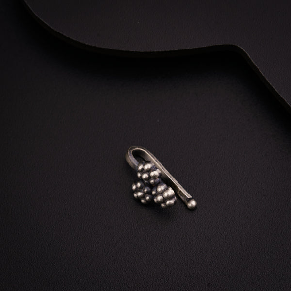 a pair of earrings sitting on top of a black surface