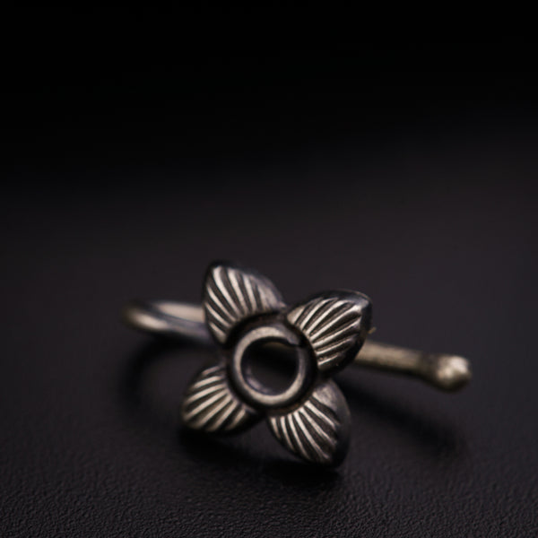 a silver ring with a flower on it