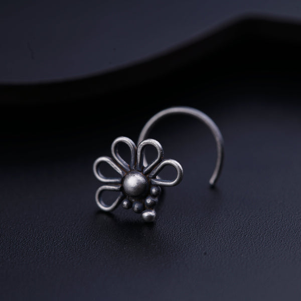 a close up of a pair of earrings on a black surface