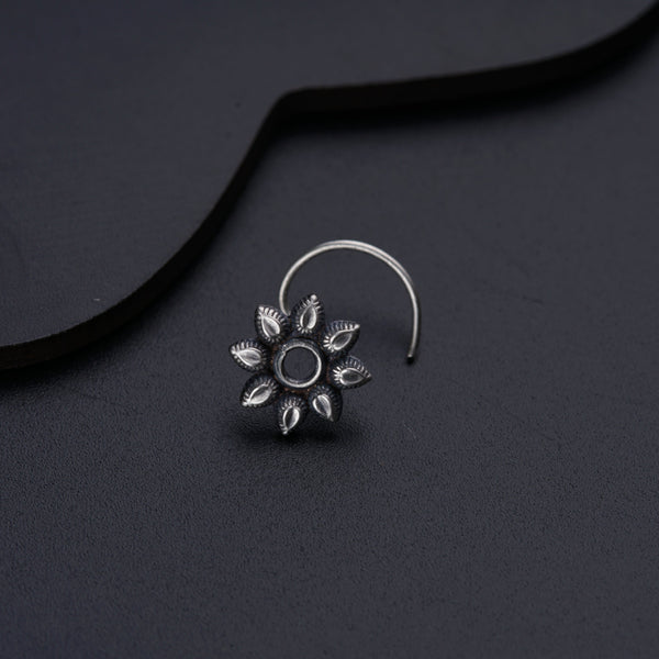 a close up of a pair of earrings on a black surface