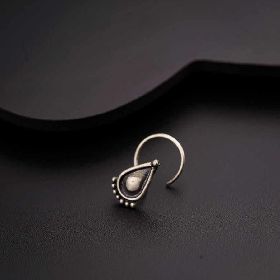 a close up of a pair of earrings on a black surface