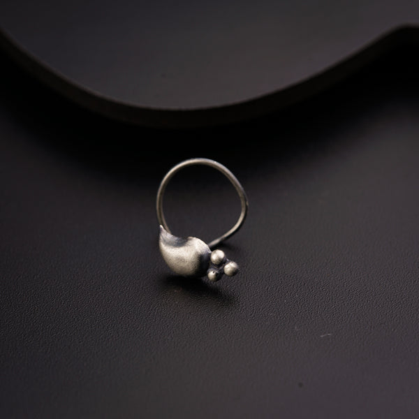 a close up of a silver ring on a black surface