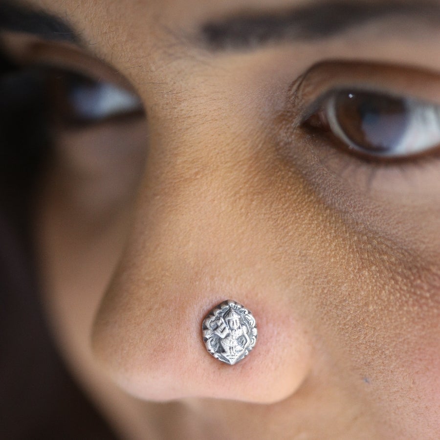 a close up of a person with a nose piercing