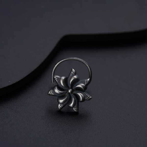 a silver ring with a flower design on it