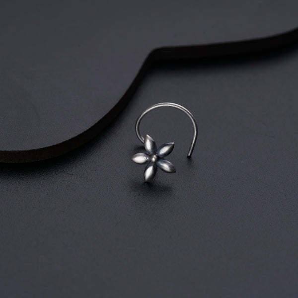 a close up of a pair of earrings on a black surface