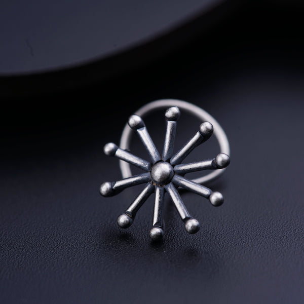 a close up of a metal object on a black surface