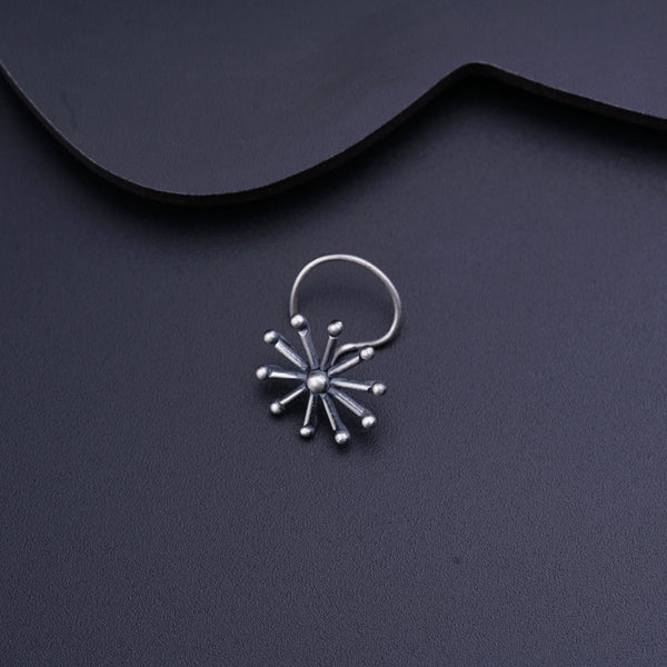 a pair of silver hoop earrings on a black surface