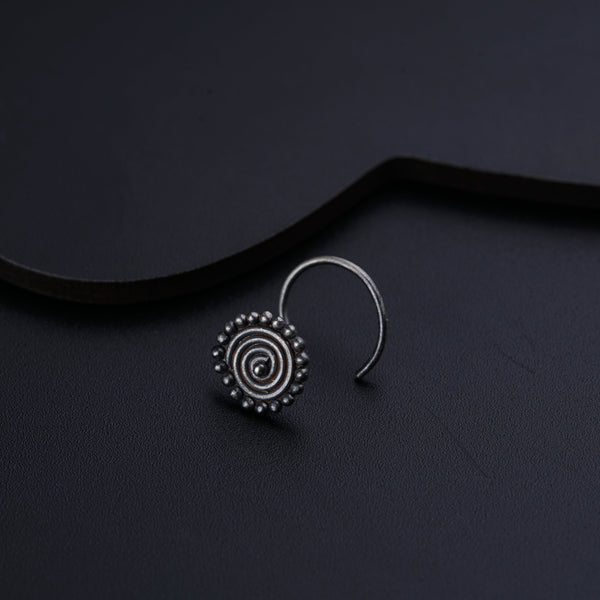 a close up of a pair of earrings on a black surface