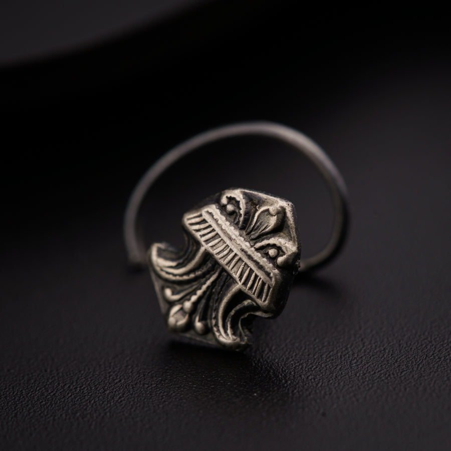 a close up of a ring on a black surface