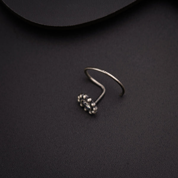 a close up of a pair of earrings on a black surface
