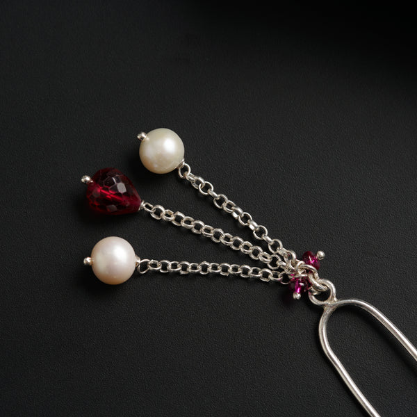 a close up of a pair of earrings on a black surface