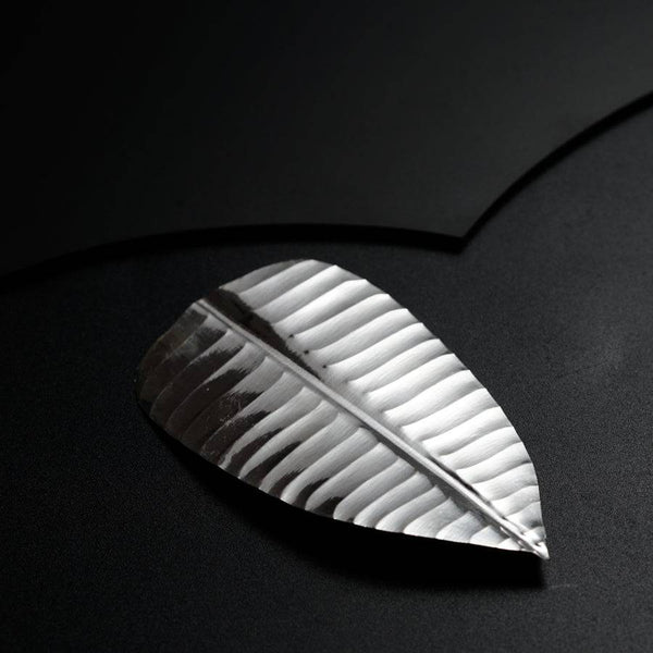 a piece of metal that is on a black surface