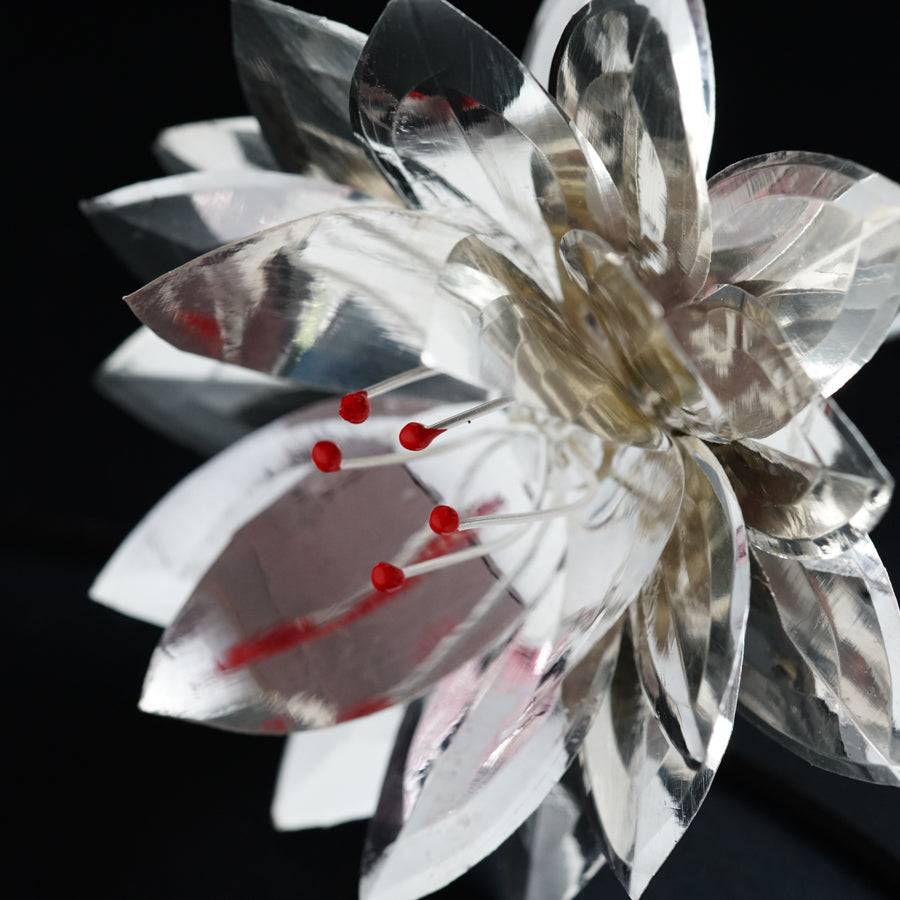 a crystal flower with red berries on it