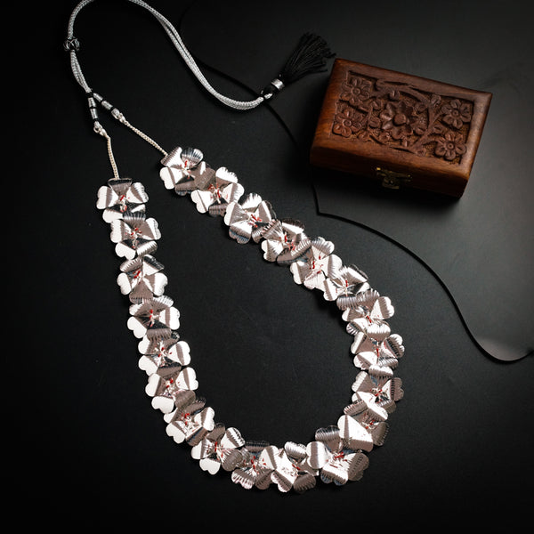 a necklace and a wooden box on a table