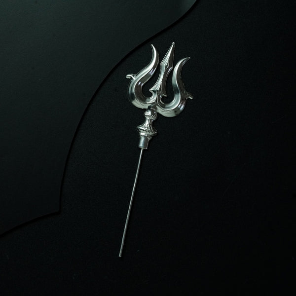 a metal hook with a long handle on a black surface
