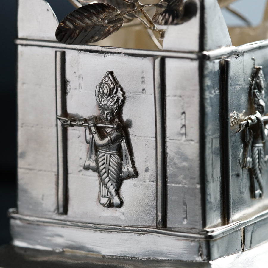 a metal box with a decorative design on it