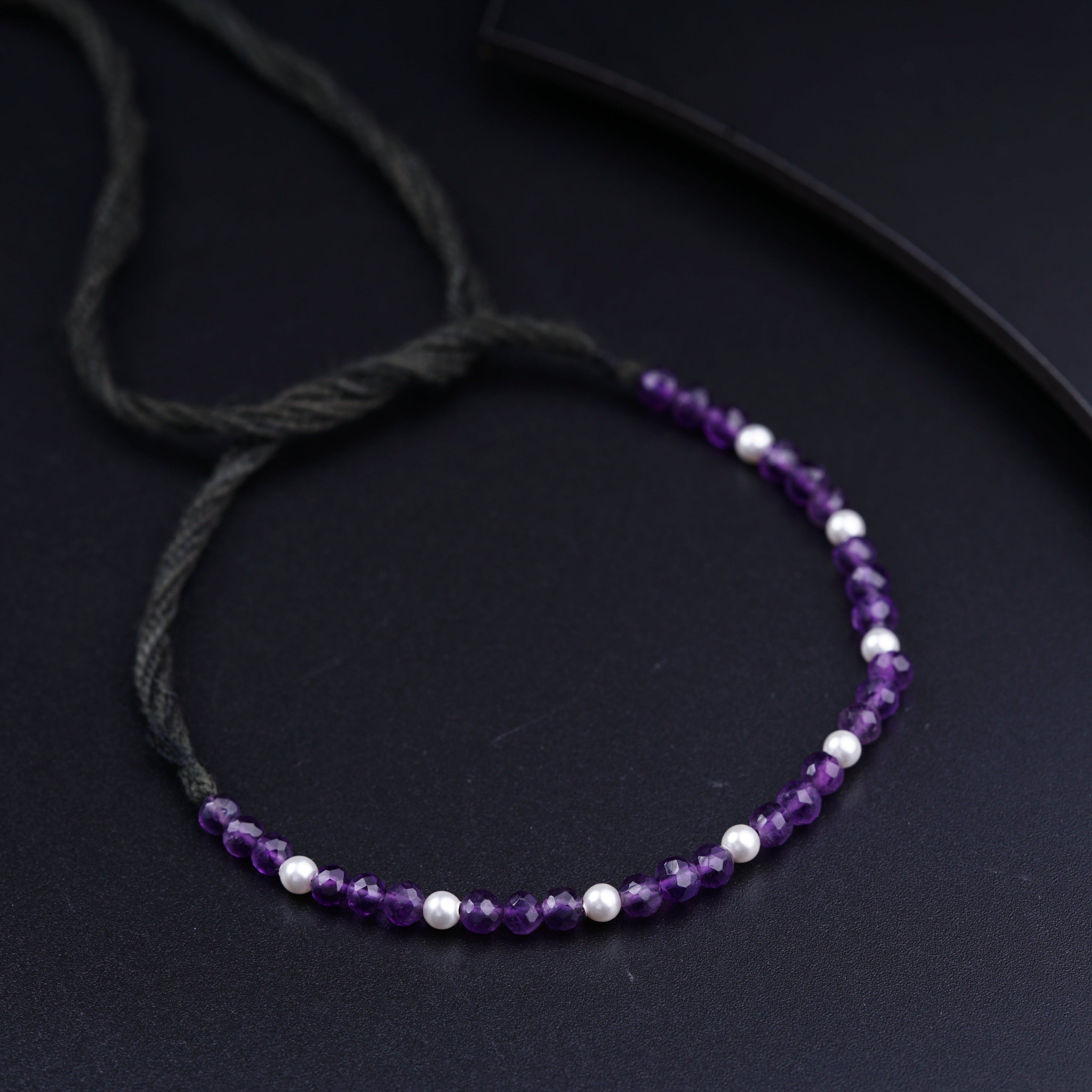 a purple beaded necklace with white beads