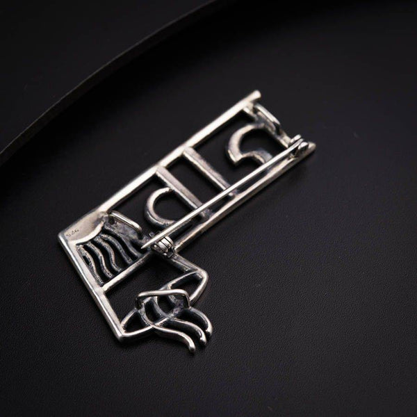 a close up of a metal object on a black surface