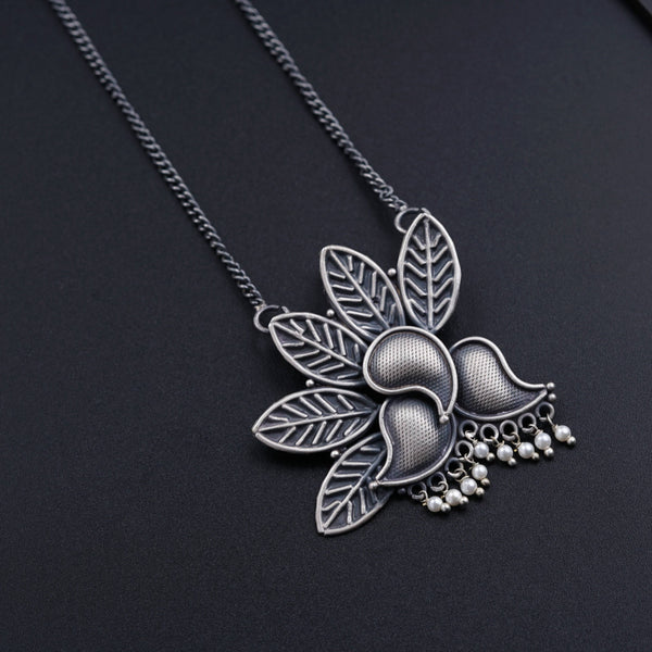 a close up of a necklace on a black surface